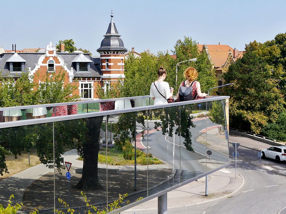 Zwei Frauen stehen auf einer Brücke auf dem Bunkerberg in Lutherstadt Wittenberg und schauen in die Ferne-