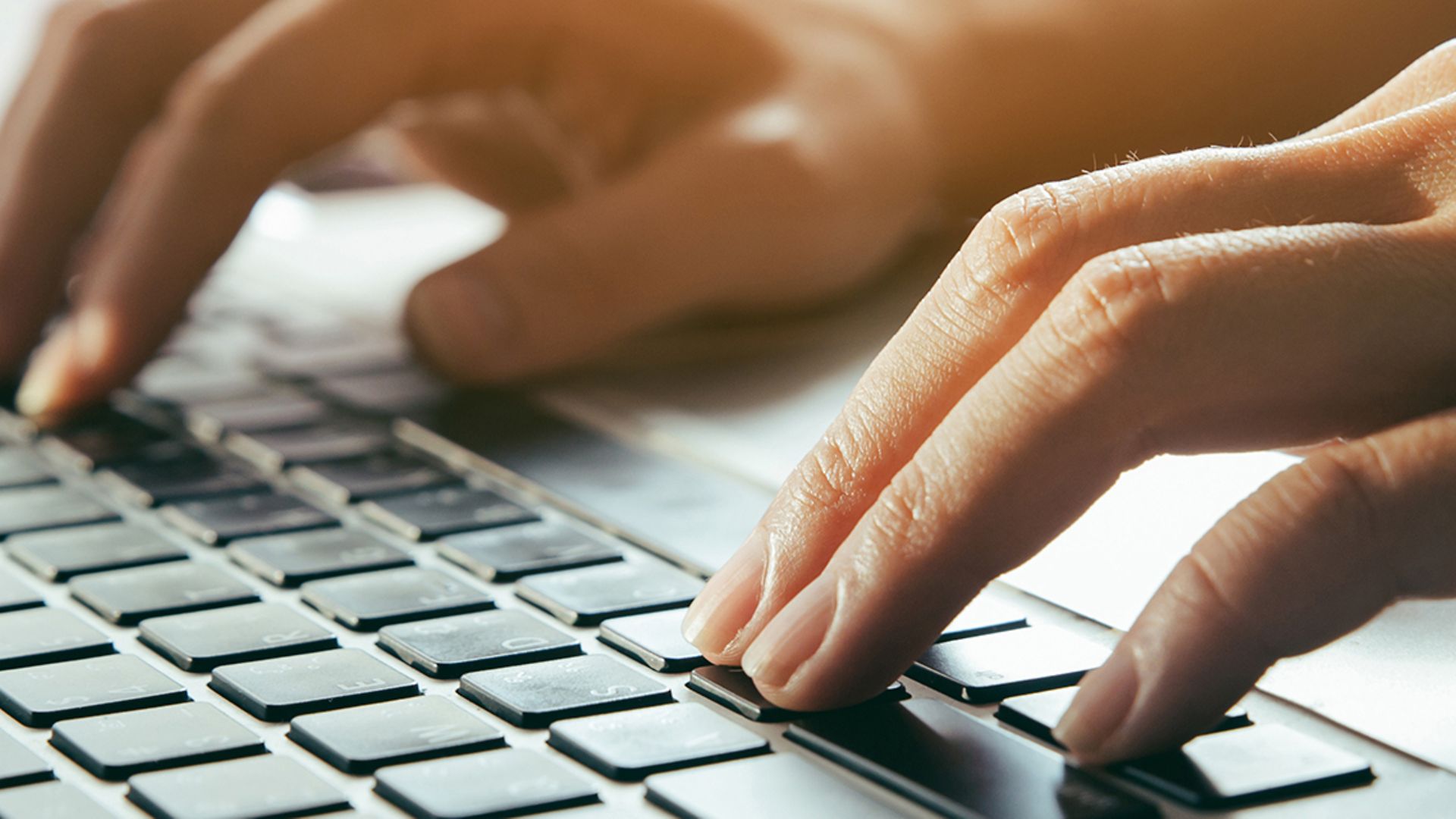 Close up fingers typing on the computer keyboard